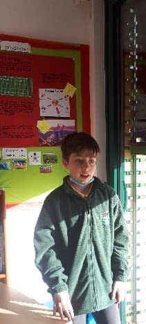 A child standing in front of a posterDescription automatically generated with medium confidence